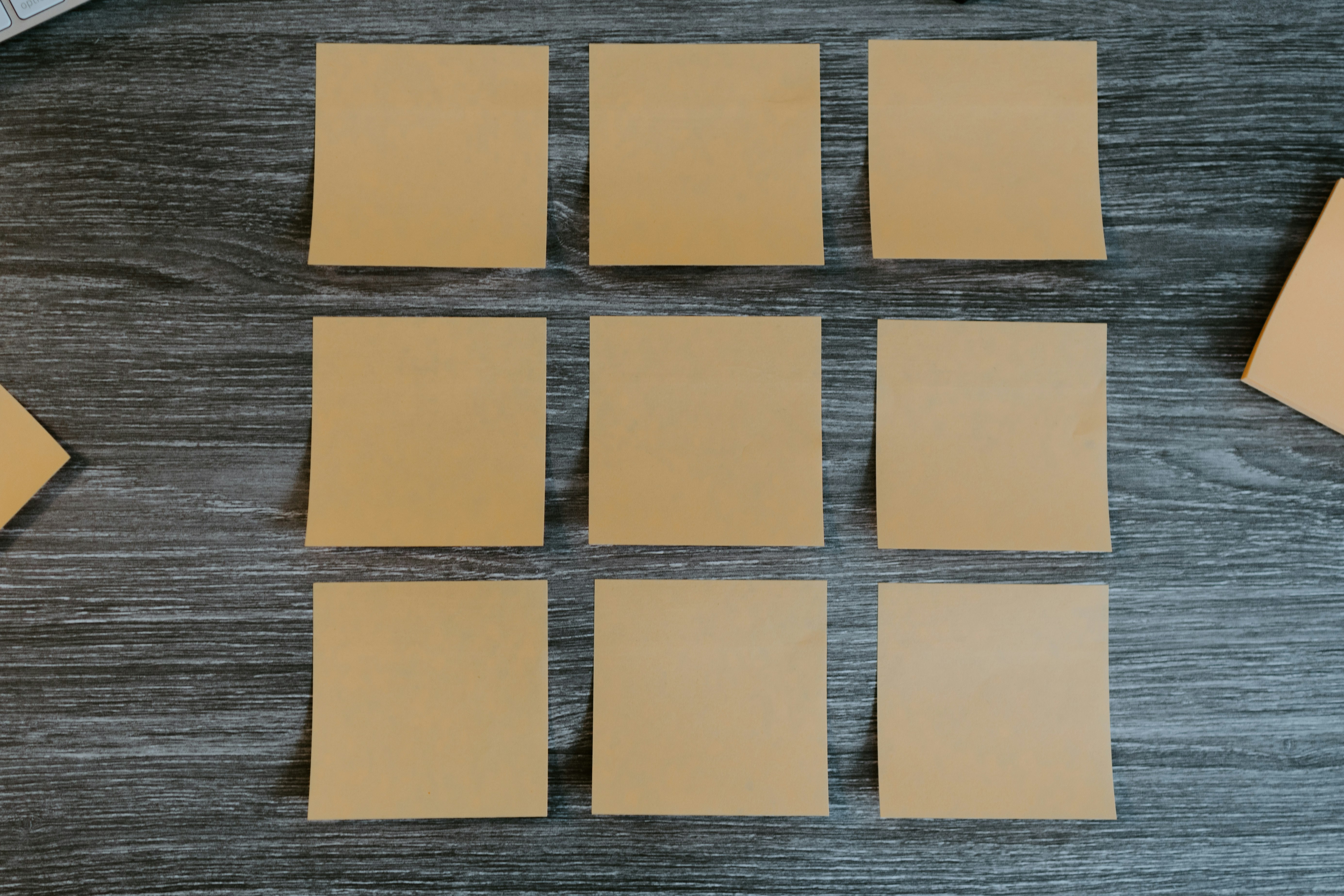 yellow sticky notes on brown wooden table
